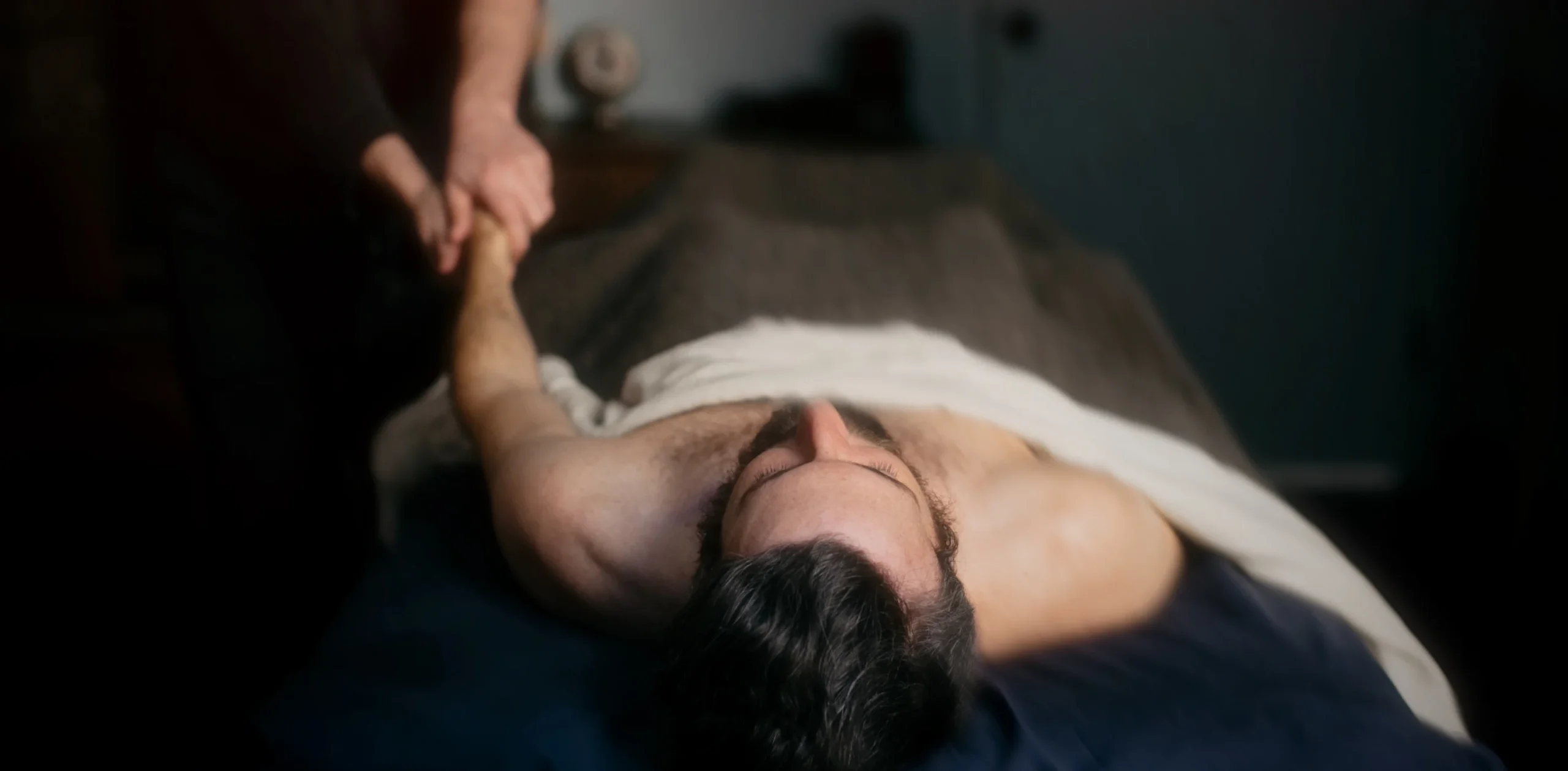 man getting a medical massage for Elbow Pain, Tennis Elbow & Golfer’s Elbow